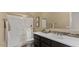 Bathroom features a vanity with a sink, decorative backsplash, and a shower with glass doors at 6917 E Ingram Cir, Mesa, AZ 85207