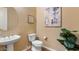 Half bathroom features round mirror, contemporary sink, toilet and neutral-toned walls at 6917 E Ingram Cir, Mesa, AZ 85207