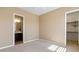 Bedroom featuring neutral walls, carpet flooring, and doorways leading to closet and bathroom at 6917 E Ingram Cir, Mesa, AZ 85207