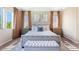 Charming bedroom with soft natural light, features upholstered bed and bench, plus stylish decor and window coverings at 6917 E Ingram Cir, Mesa, AZ 85207