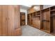Spacious walk-in closet boasts custom shelving, drawers, and ample storage with plush carpet at 6917 E Ingram Cir, Mesa, AZ 85207