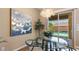 Bright dining area with modern chandelier, glass table, and views of the backyard pool at 6917 E Ingram Cir, Mesa, AZ 85207