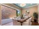 Elegant dining room with stylish furniture, decorative lighting, and a view to the outside patio at 6917 E Ingram Cir, Mesa, AZ 85207