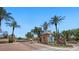 Annecy community entrance with desert landscaping, palm trees and a guard house with blue shutters at 6917 E Ingram Cir, Mesa, AZ 85207