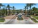 Annecy community entrance showcasing a guard house, desert landscaping and palm trees at 6917 E Ingram Cir, Mesa, AZ 85207