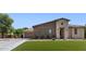 Attractive home featuring stone accents, a three-car garage, and meticulously manicured landscaping at 6917 E Ingram Cir, Mesa, AZ 85207