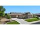 Beautiful single-Gathering home showcasing a well-manicured lawn and a three-car garage at 6917 E Ingram Cir, Mesa, AZ 85207