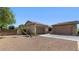 Back elevation highlighting three-car garage, with partial desert landscaping at 6917 E Ingram Cir, Mesa, AZ 85207