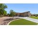 Charming single-story home featuring a three-car garage, stone accents, and well-manicured landscaping at 6917 E Ingram Cir, Mesa, AZ 85207