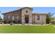 Beautiful home with a stone facade, manicured lawn, and an inviting entrance at 6917 E Ingram Cir, Mesa, AZ 85207