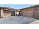Spacious three-car garage with neutral doors and a large concrete driveway at 6917 E Ingram Cir, Mesa, AZ 85207