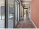Hallway features large glass sliders for access to outdoor space, tiled floors, and neutral paint at 6917 E Ingram Cir, Mesa, AZ 85207