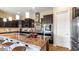 Spacious kitchen featuring dark cabinetry, granite countertops, and stainless steel appliances at 6917 E Ingram Cir, Mesa, AZ 85207