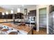 Well-equipped kitchen with dark cabinets, stainless steel appliances, granite counters, and pantry at 6917 E Ingram Cir, Mesa, AZ 85207