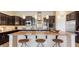 Gourmet kitchen with stainless steel appliances, granite countertops, and dark wood cabinetry, perfect for cooking at 6917 E Ingram Cir, Mesa, AZ 85207