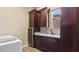 Functional laundry room with rich cabinetry, granite countertops, and beverage cooler at 6917 E Ingram Cir, Mesa, AZ 85207