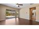 Open living room with sleek floors, ceiling fan, and sliding doors to the outdoor living space at 6917 E Ingram Cir, Mesa, AZ 85207