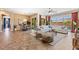 Sun-filled living room boasts an open layout, seamlessly blending the dining and lounging areas with backyard views at 6917 E Ingram Cir, Mesa, AZ 85207