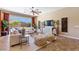 Light and airy living room offers a comfortable seating area with modern decor and backyard views at 6917 E Ingram Cir, Mesa, AZ 85207