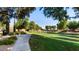 A lush park with sidewalks, benches, and greenery at 6917 E Ingram Cir, Mesa, AZ 85207