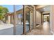 Covered patio with tiled floor, sliding glass doors, and view of outdoor kitchen area at 6917 E Ingram Cir, Mesa, AZ 85207
