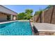 Gorgeous pool area features a rock waterfall and well-maintained landscaping at 6917 E Ingram Cir, Mesa, AZ 85207