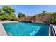Stunning swimming pool with elegant waterfall feature and mature landscaping at 6917 E Ingram Cir, Mesa, AZ 85207