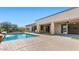 Resort-style pool with baja step, rock accents, and covered patio at 6917 E Ingram Cir, Mesa, AZ 85207