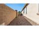 Side yard featuring low-maintenance desert landscaping and exterior house view at 6917 E Ingram Cir, Mesa, AZ 85207