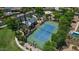 Aerial view of the tennis court with a nearby clubhouse and lush trees at 6917 E Ingram Cir, Mesa, AZ 85207