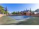 Community tennis court and clubhouse features professional surfaces and lighting at 6917 E Ingram Cir, Mesa, AZ 85207