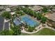 Aerial view of the tennis court, adjacent cabana, mature trees, and community landscaping at 6917 E Ingram Cir, Mesa, AZ 85207