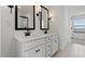 Elegant bathroom with dual sinks, vanities with stylish black hardware, and well-lit mirrors at 7327 S 76Th Ln, Laveen, AZ 85339