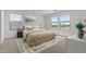 Cozy bedroom showcasing abundant natural light from windows and complemented by stylish décor at 7327 S 76Th Ln, Laveen, AZ 85339