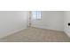 Cozy, bright bedroom with neutral carpet, single window, and white walls at 7327 S 76Th Ln, Laveen, AZ 85339
