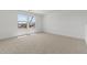 A sunlit room featuring neutral carpet and two windows for natural light at 7327 S 76Th Ln, Laveen, AZ 85339