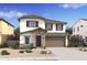 Charming two-story home with stone accents, attached two-car garage, and landscaped front yard at 7327 S 76Th Ln, Laveen, AZ 85339