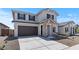 Inviting home featuring a spacious driveway, two-car garage, stone details, and a manicured front landscape at 7327 S 76Th Ln, Laveen, AZ 85339