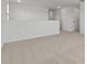 A spacious, carpeted loft area with white walls and access to multiple doorways at 7327 S 76Th Ln, Laveen, AZ 85339
