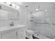 Updated bathroom with white cabinets, tile finishes, and glass enclosed shower at 7920 E Camelback Rd # 104, Scottsdale, AZ 85251