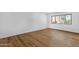Bright bedroom featuring wood floors and a large window with exterior views at 7920 E Camelback Rd # 104, Scottsdale, AZ 85251