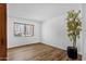 Bright bedroom featuring wood-look floors and a scenic window view at 7920 E Camelback Rd # 104, Scottsdale, AZ 85251