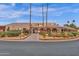 View of community entrance with desert landscaping including cacti and floral gardens at 7920 E Camelback Rd # 104, Scottsdale, AZ 85251