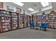 Bright community library with walls of books and comfortable seating at 7920 E Camelback Rd # 104, Scottsdale, AZ 85251
