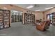 Community library with books on shelves and leather chairs to sit and read at 7920 E Camelback Rd # 104, Scottsdale, AZ 85251