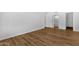 Wood floors in a hallway with a view of the bathroom with bright, white finishes at 7920 E Camelback Rd # 104, Scottsdale, AZ 85251