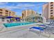 Relaxing pool area with clear blue water, lounge chairs, and a covered shelter for sunny days at 7920 E Camelback Rd # 104, Scottsdale, AZ 85251
