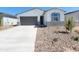 Welcoming single-story home with a two-car garage and desert landscaping at 8576 W Yorktown Ct, Florence, AZ 85132