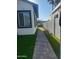A paver stone walkway leads to a backyard with artificial turf, providing a low-maintenance outdoor space at 8879 E Friess Dr, Scottsdale, AZ 85260