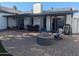 Inviting backyard patio with a fire pit, lounge chairs, and outdoor dining area, perfect for entertaining at 8879 E Friess Dr, Scottsdale, AZ 85260